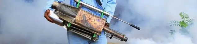 Fumigation technician using a fogger for deep pest treatment in Oakland, CA