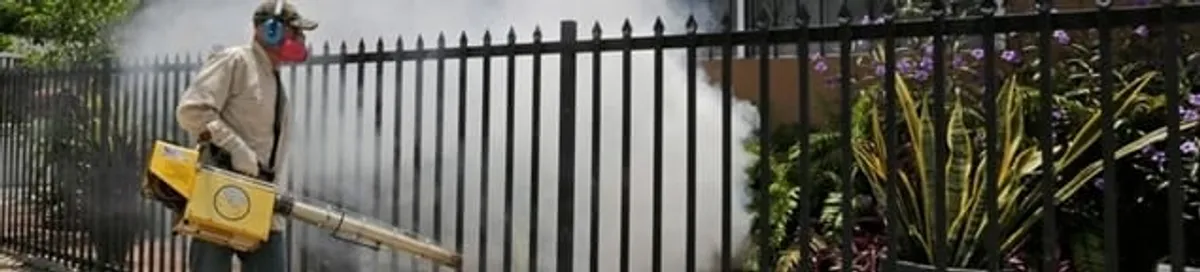 Mosquito control technician fogging a yard perimeter for mosquito reduction in Oakland, CA